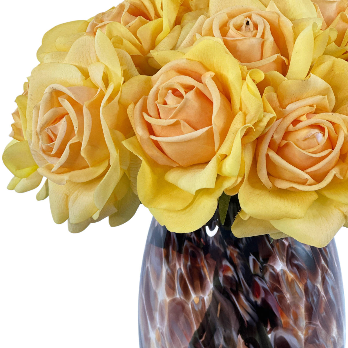 Close up of Artificial Open yellow roses in stunning Prague vase