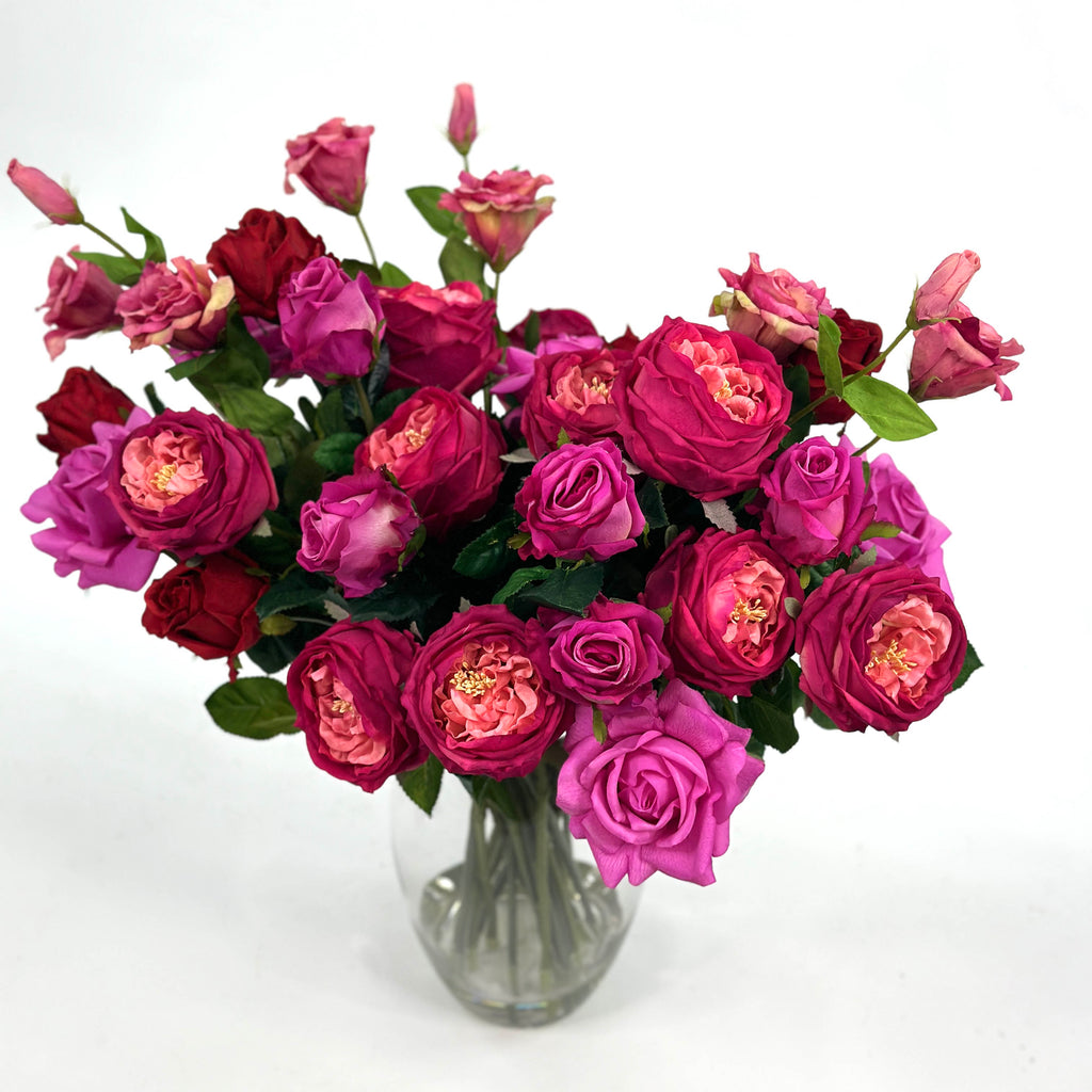 Top view of Arrangement of Mixed Rosed including Cabbage rose , Pink cerice Purple and red roses. 60cm high and 60cm wide - Set in glass vase with faux water.