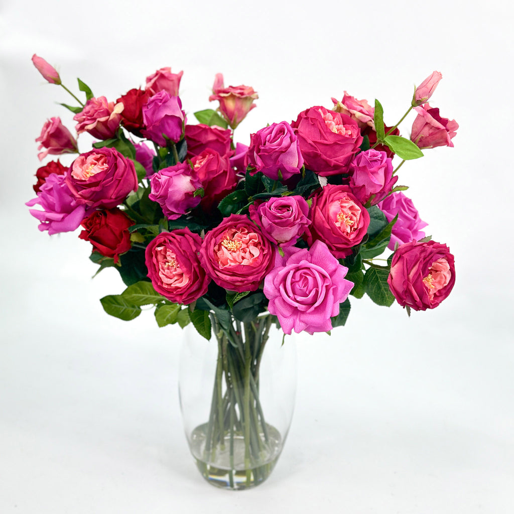 Arrangement of Mixed Rosed including Cabbage rose , Pink cerice Purple and red roses. 60cm high and 60cm wide - Set in glass vase with faux water