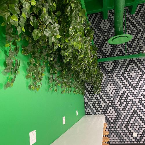 Hanging artificial ivy plants in this restaurant add softness to a stark wall. Artificial plants, trees, foliage and more available from Plant Couture. Shop online www.plantcouture.co.za