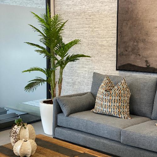 A potted palm in a fibreglass pot adds some style to an office space or living room. This artificial tree and plants available from Plant Couture. Shop online www.plantcouture.co.za