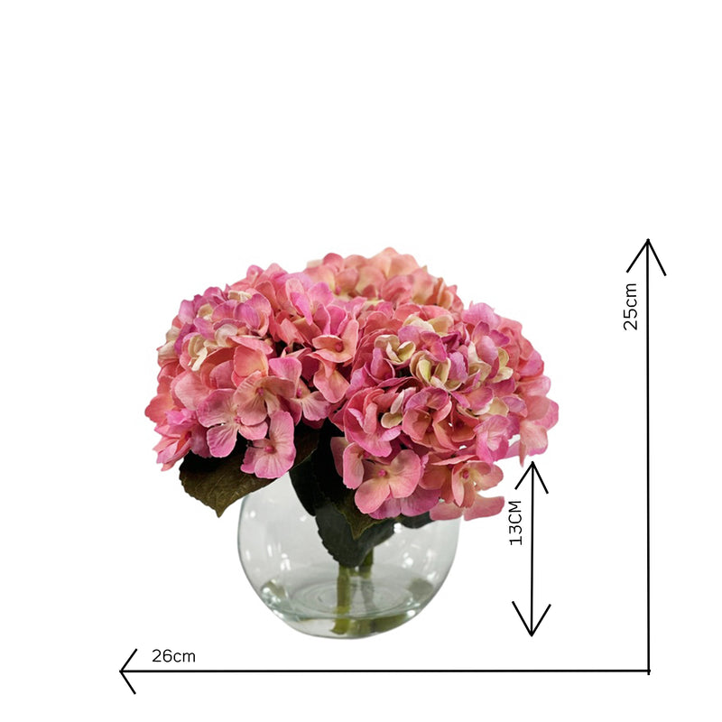 Faux Pink Hydrangea arrangement in a clear glass vase with faux water on a white background with measurements