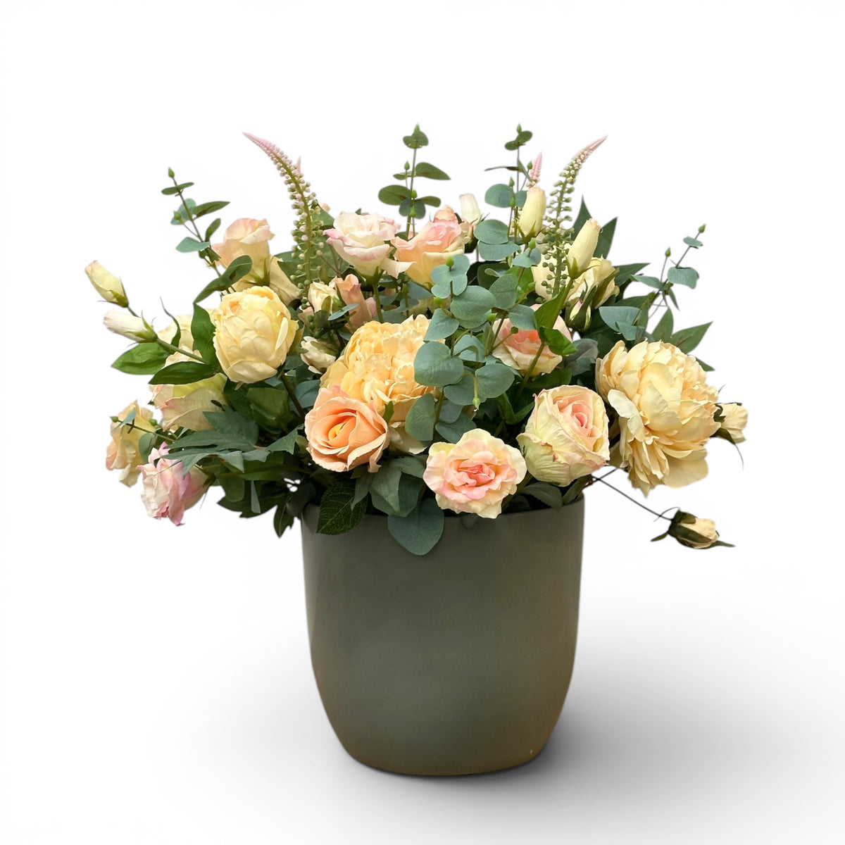 Faux Floral arrangement in a green vase on a white background