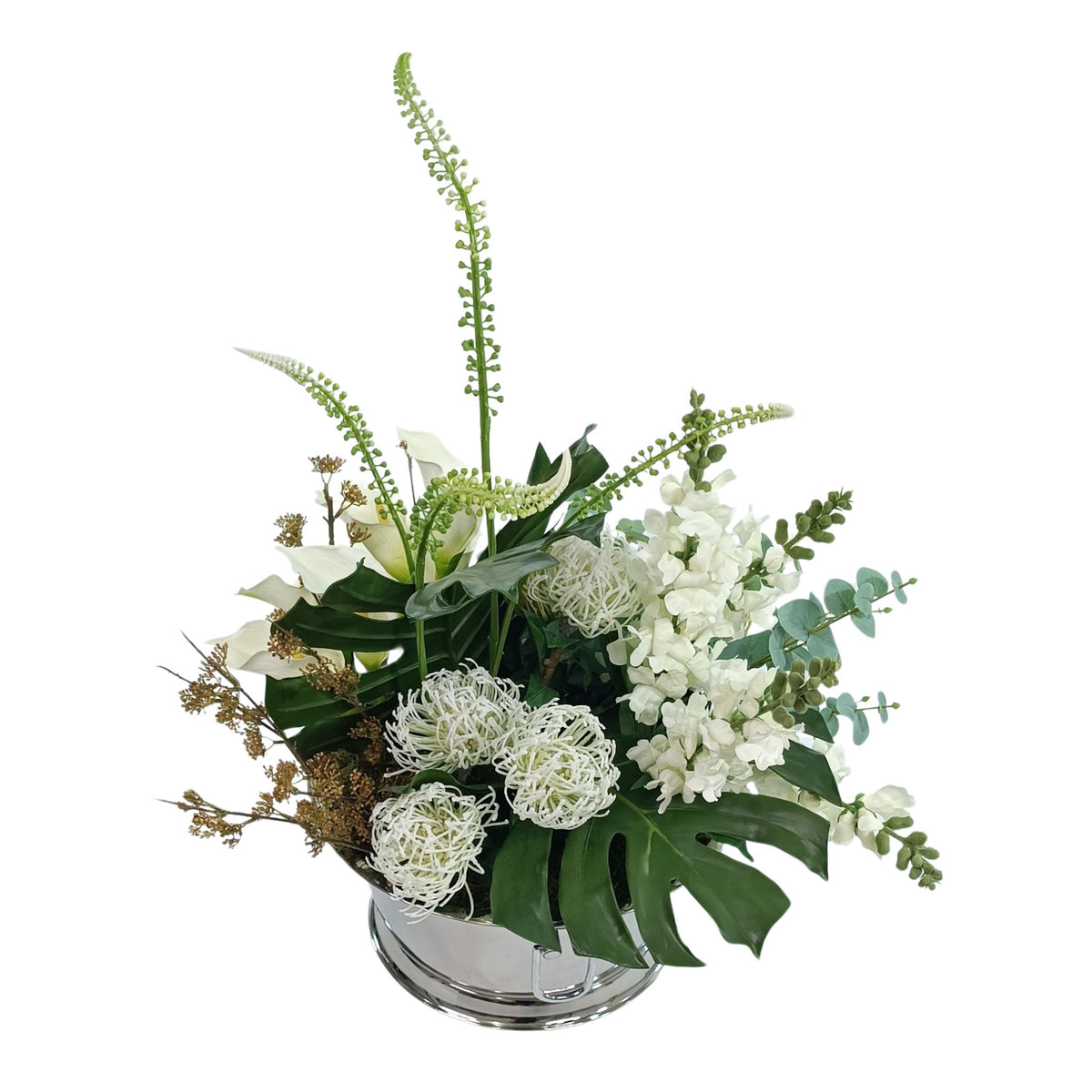 Top view of Faux Arrangement with Monstera leaves and White Snapdragon, Pincushions and Arum Lilies in Large silver Tin.