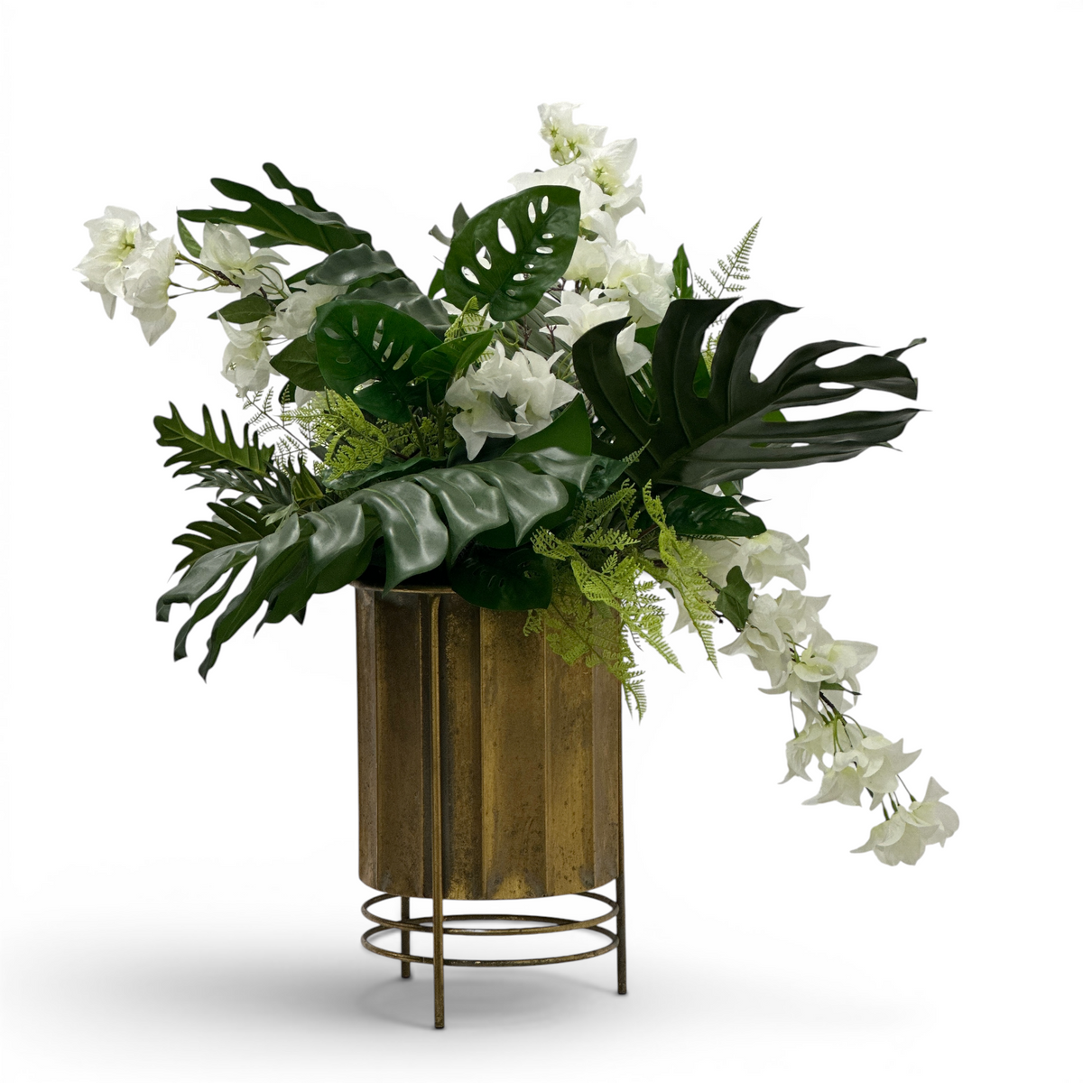 Decorative faux arrangement of green plants and white Bougainvillea flowers in a gold pot on a white background