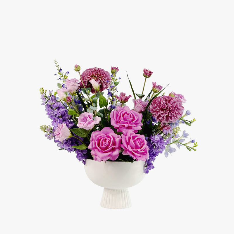 Faux Mix purple Flower arrangement with Dahlia Roses Freezia Snapdragon & Eucaluptus is footed white Ceramic