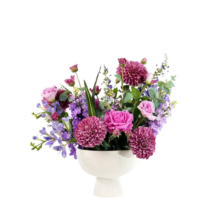 Bouquet of flowers in a white vase on a white background