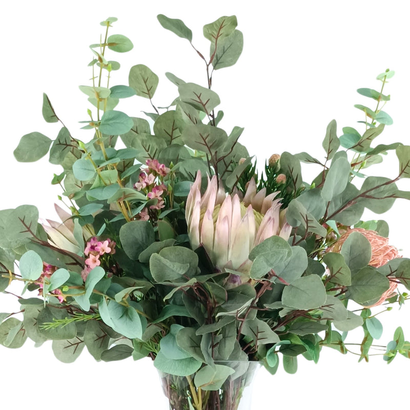 Protea Eucalyptus Mix Arrangement in Glass Vase. Close up view. Available from Plant Couture.