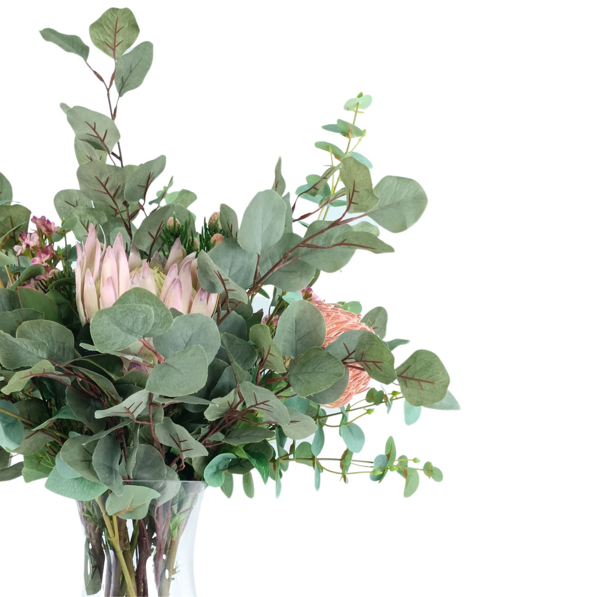 Protea Eucalyptus Mix Arrangement in Glass Vase. Close up view of the silk flower arrangement. Available from Plant Couture.