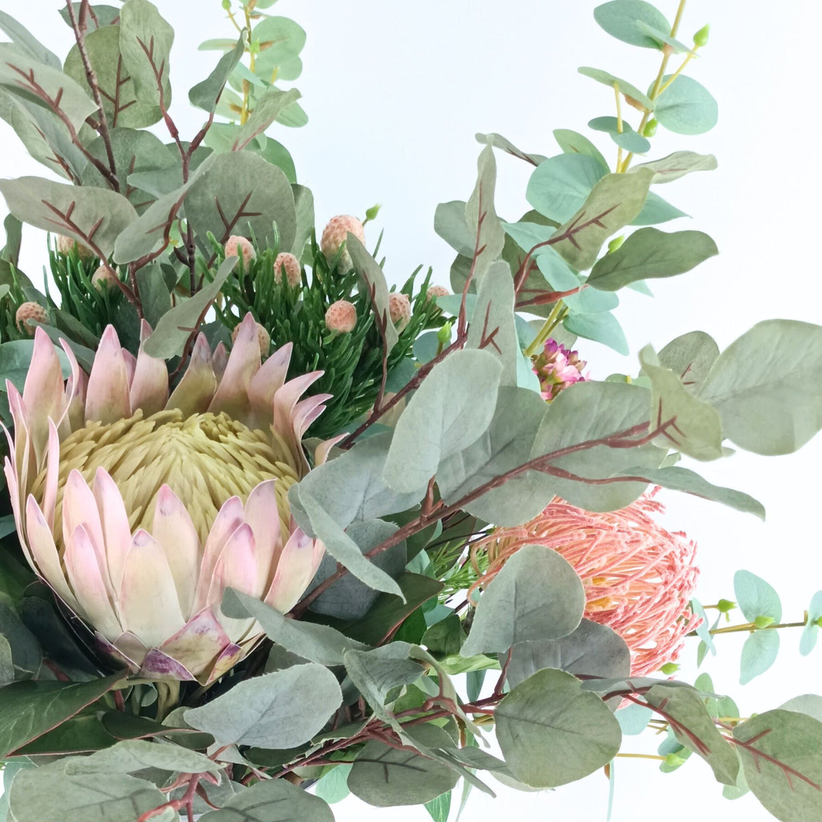 Protea Eucalyptus Mix Arrangement in Glass Vase. Close up detailed view of the silk flower arrangement. Available from Plant Couture.