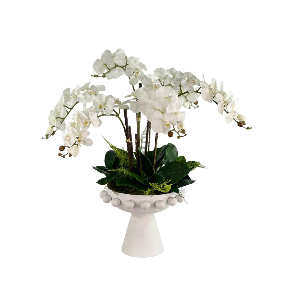White orchid arrangement on a decorative white pedestal with a plain white background