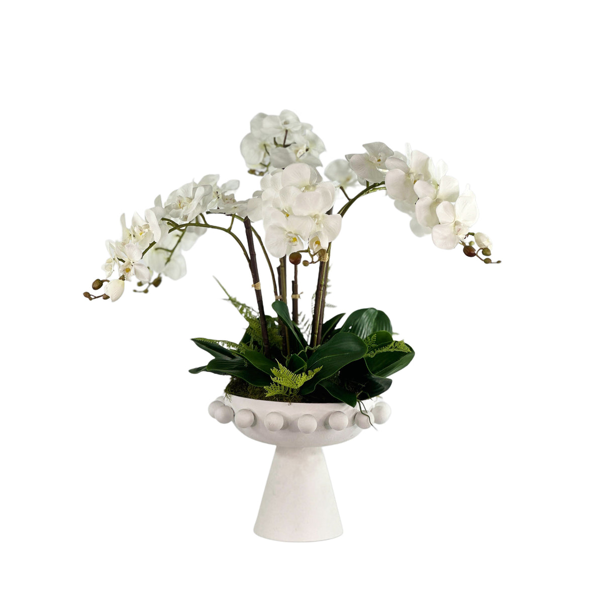 White orchid arrangement in a decorative white vase on a white background