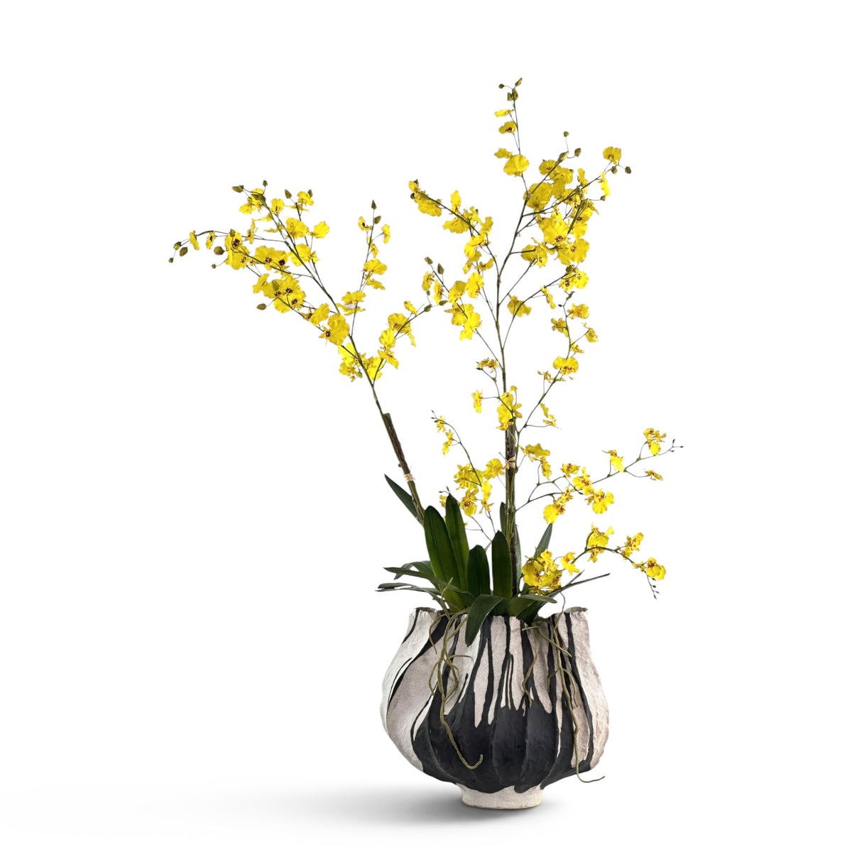 Yellow faux Dancing Orchids in a zebra-patterned  ceramic vase on a white background