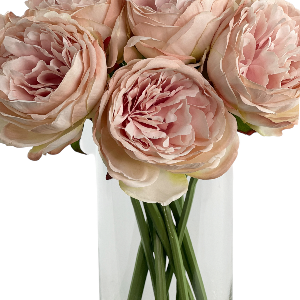 Light Pink Peony stems in a clear glass vase with faux water