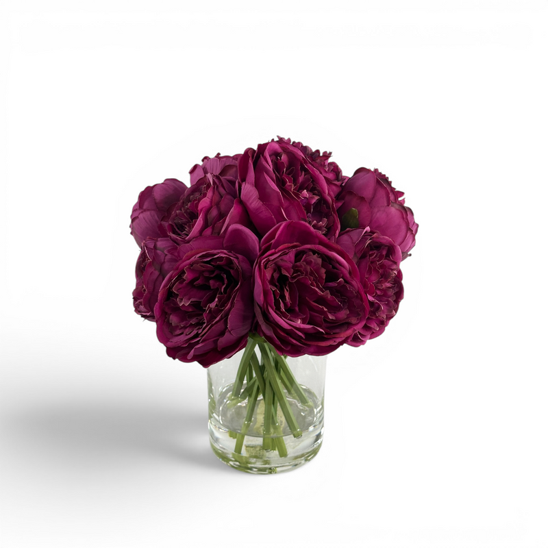 Artificial Purple Peony stems in a clear glass vase with artificial water