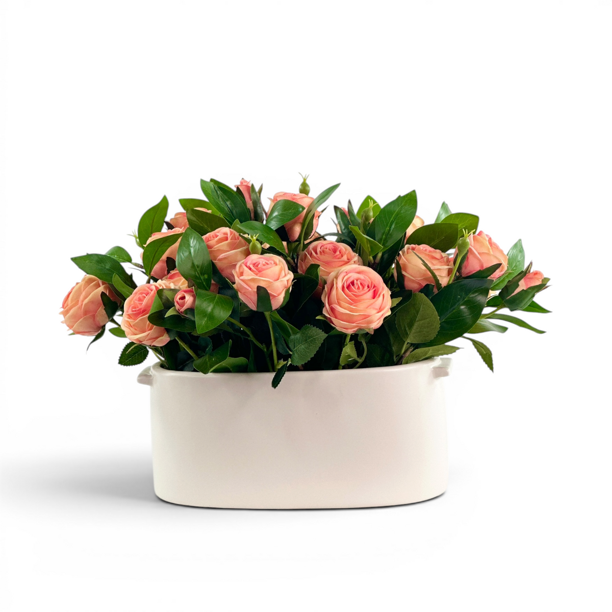 Faux Peach Roses with foliage in white ceramic planter