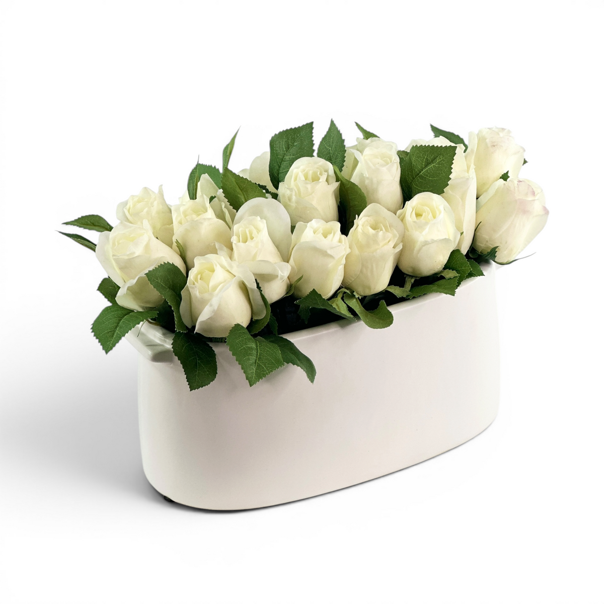 White artificial rosebuds set in a white ceramic pot