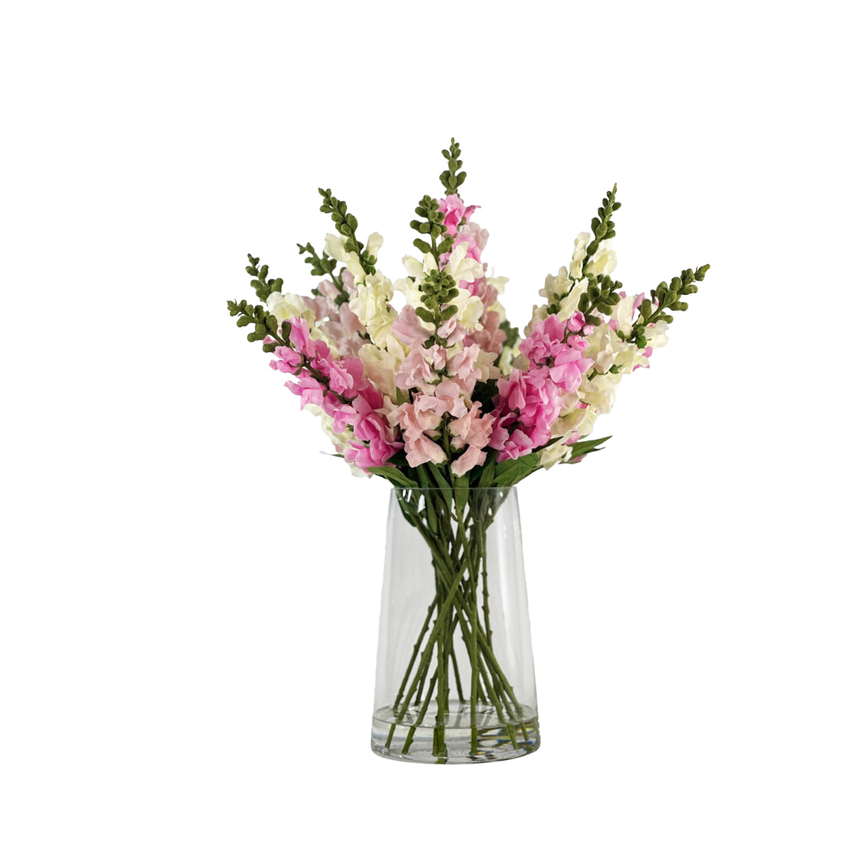 Bouquet of faux pink and white snapdragons in a clear glass vase with faux water on a white background