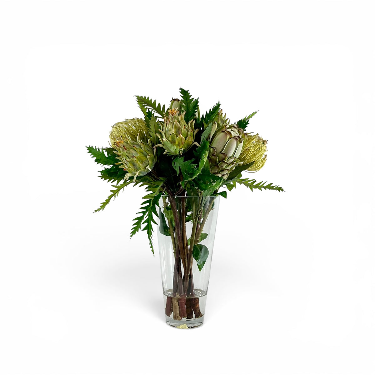 Protea and Artichoke arrangement in a clear cone vase.