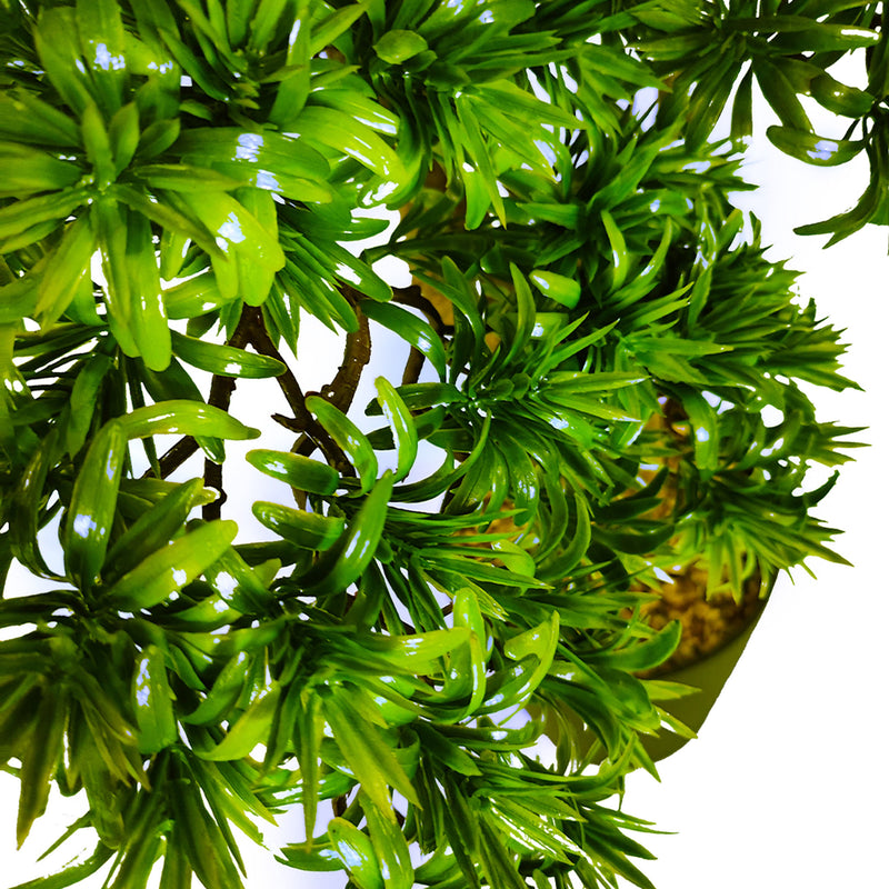 Close-up of a green artificial Bonzai on a white background