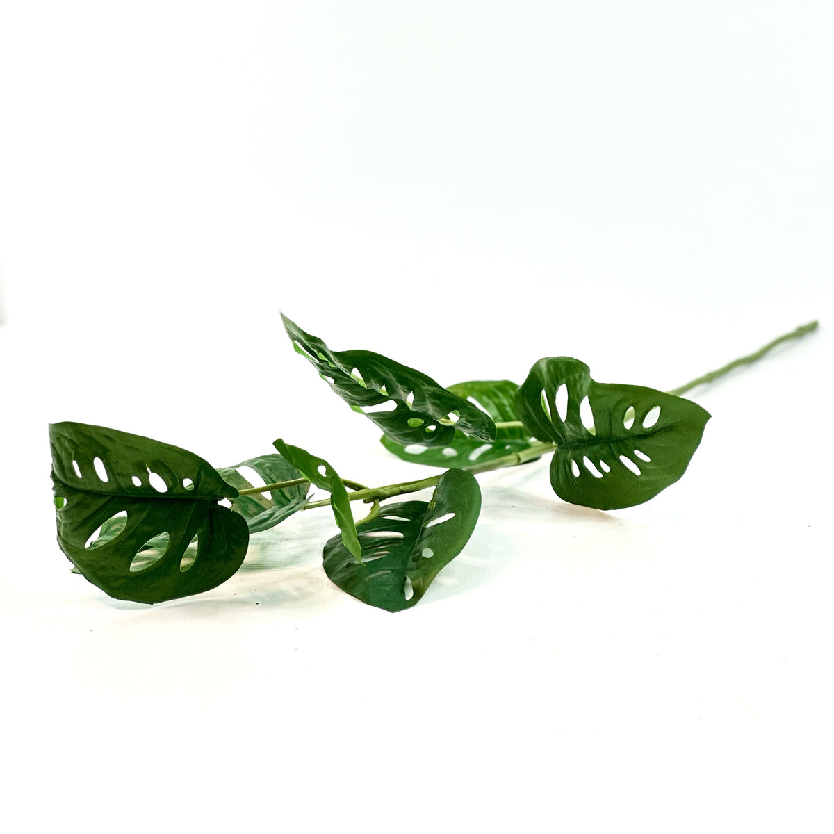 Fake Monkey Monstera stem real touch 81cm with 7 green leaves with the natural holes monstera plant often has.
