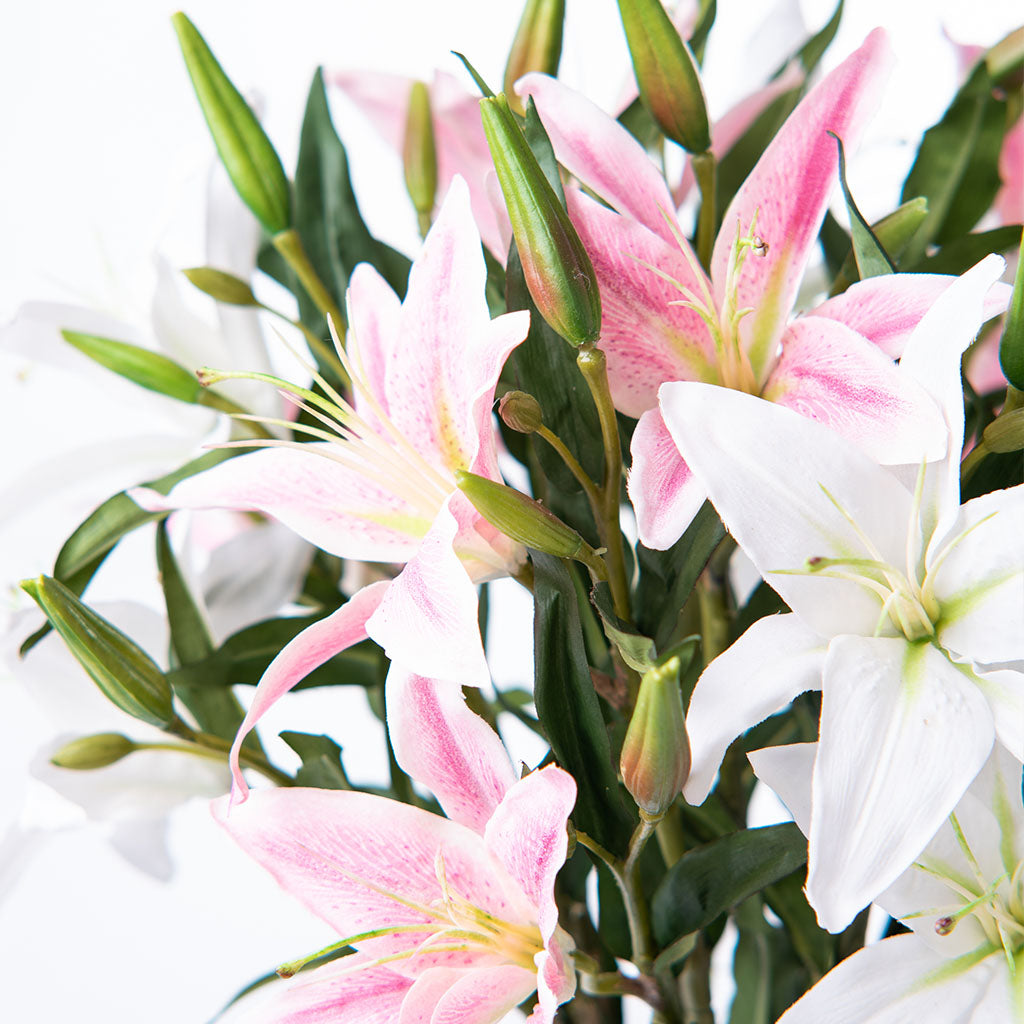 Close up of Flowers of Artificial Pink and White Lily Arrangement in faux water